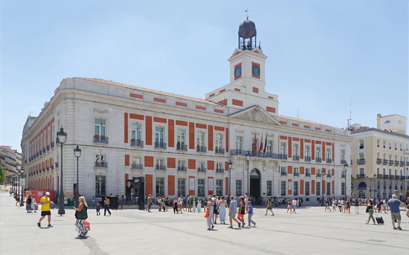 The historic Real Casa de Correos building in the bustling Puerta del Sol square in Madrid, Spain